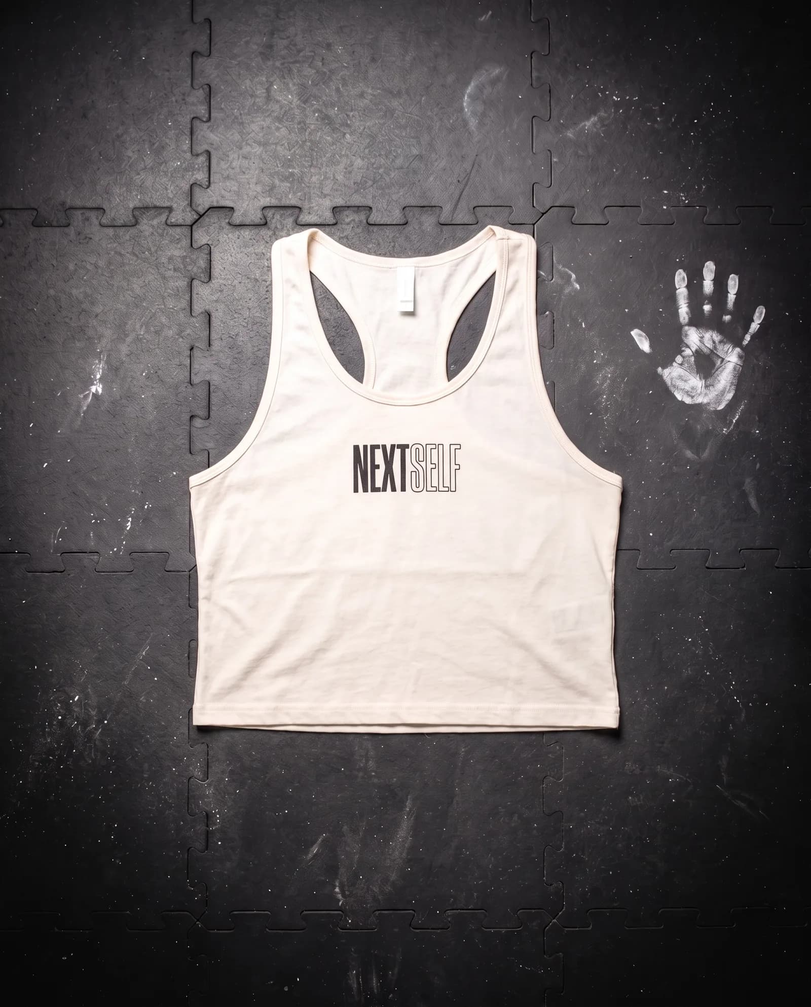 Crop Tank in Chalk, laid flat on a gym floor